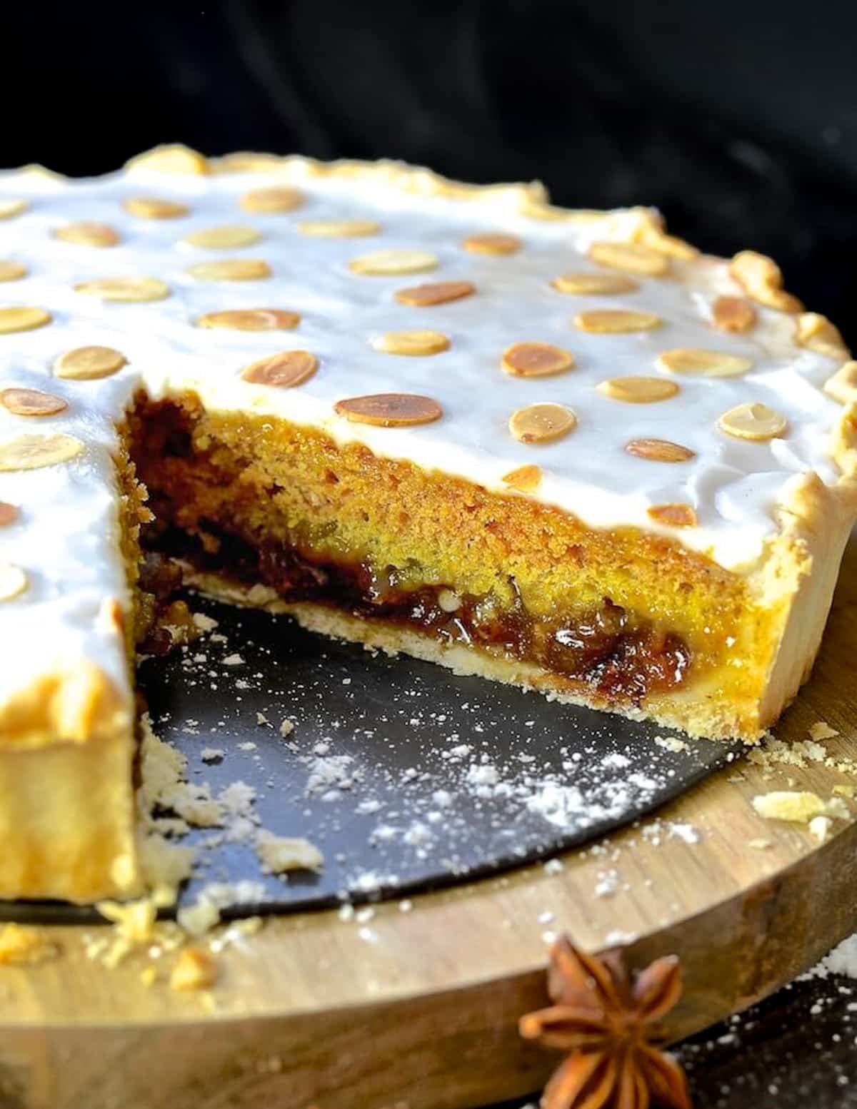 A mincemeat tart with a slice taken out to show the inside