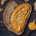 a slice of wholewheat bread spread with gingerbread peanut butter