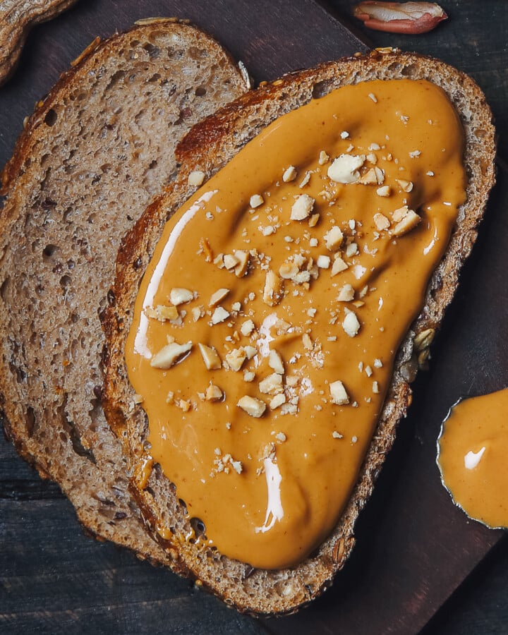 a slice of wholewheat bread spread with gingerbread peanut butter