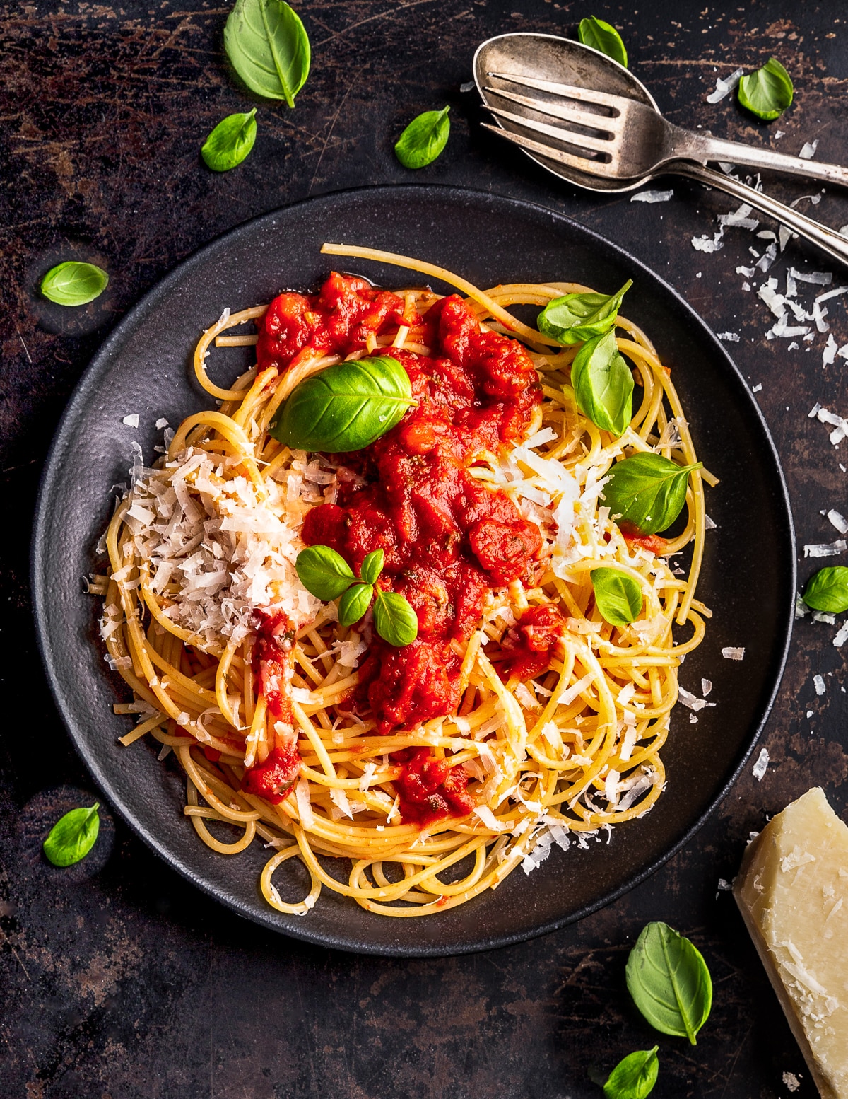 a bowl of spaghetti with marinara sauce and vegan parmesan