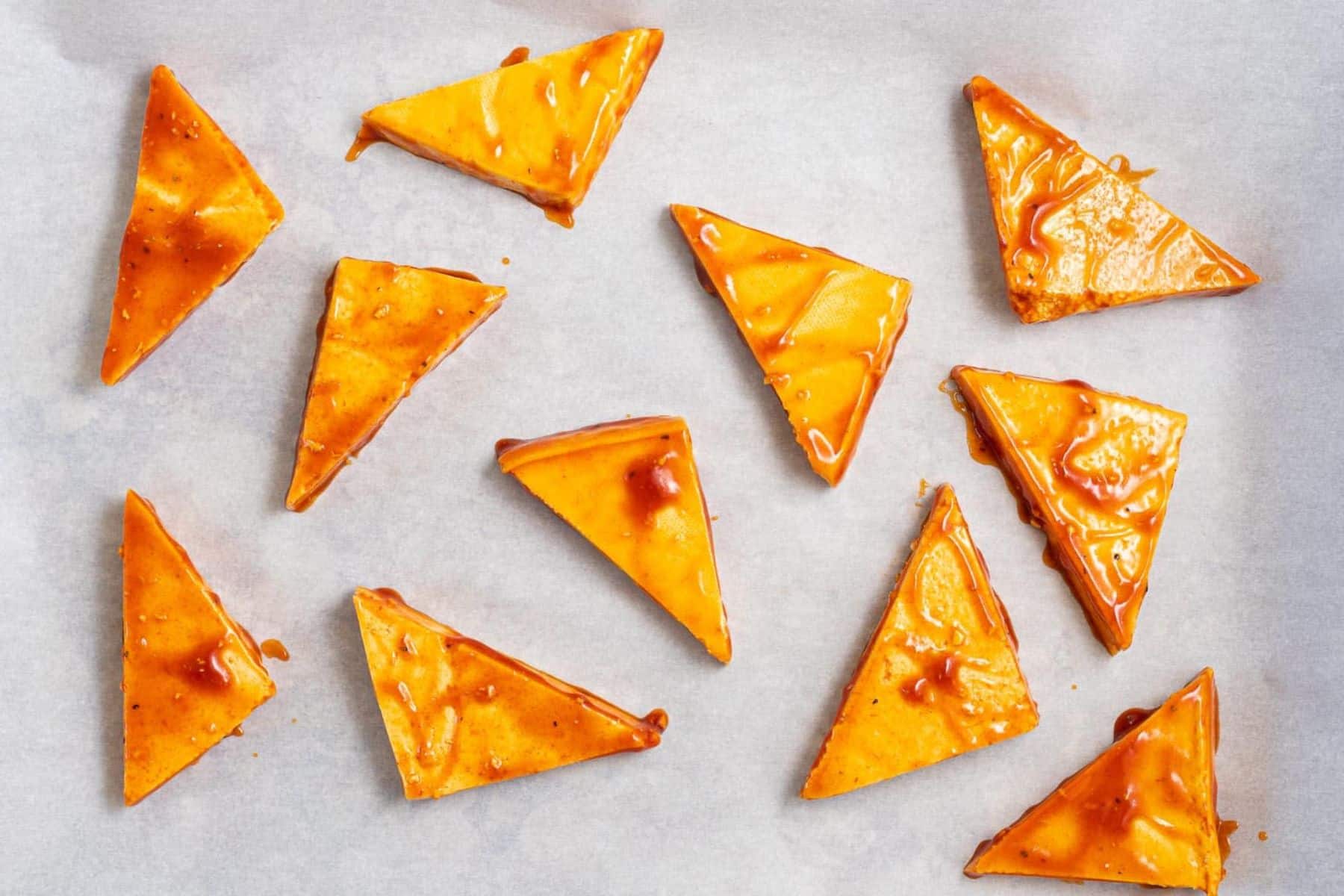 uncooked tofu triangles coated in glaze