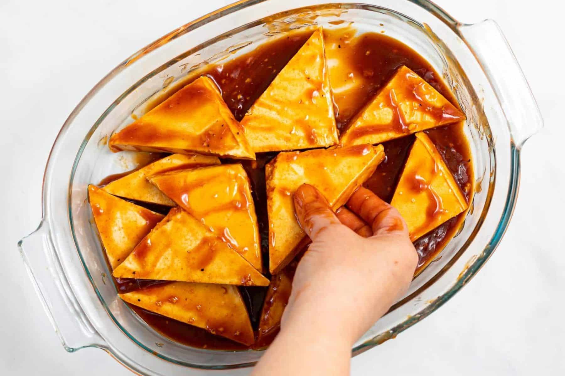 tofu triangles in a dish with glaze