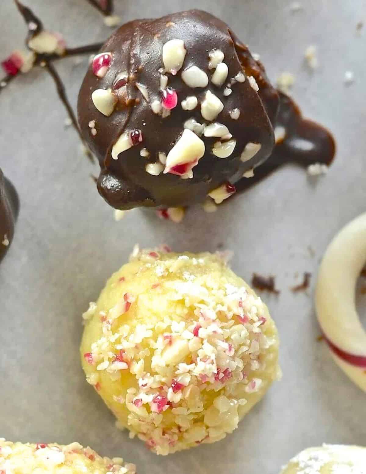 a chocolate coated truffle and a plain one with crushed candy cane sprinkles