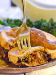 an individual mushroom pie with a slice cut