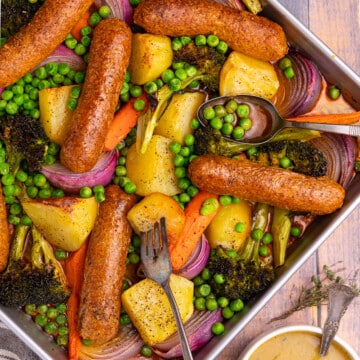 sheet pan sausage dinner with roast potatoes and veggies