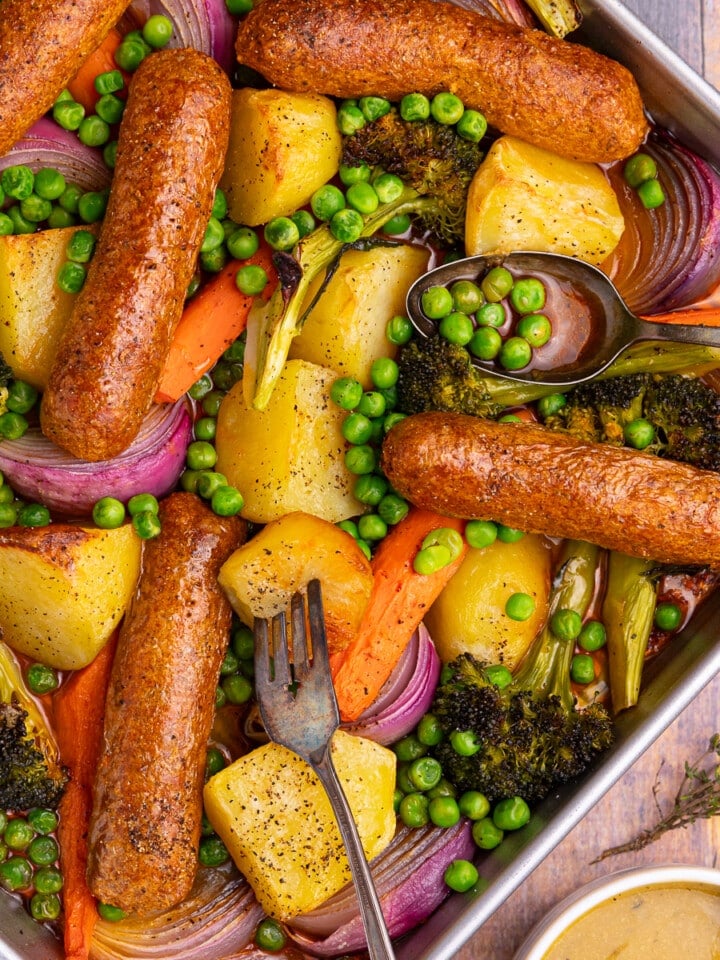 sheet pan sausage dinner with roast potatoes and veggies