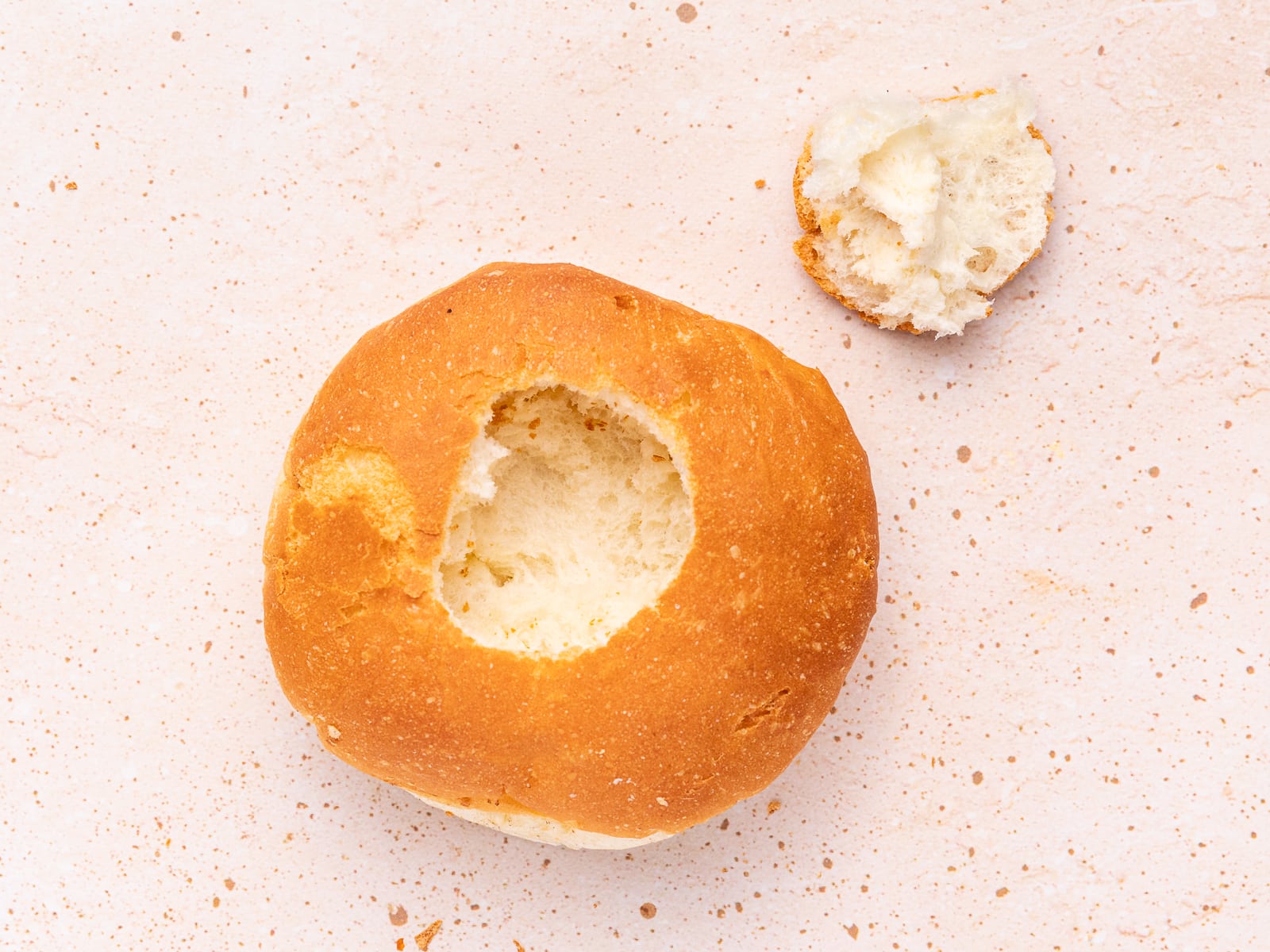 a bread roll with a hole cut out of the top