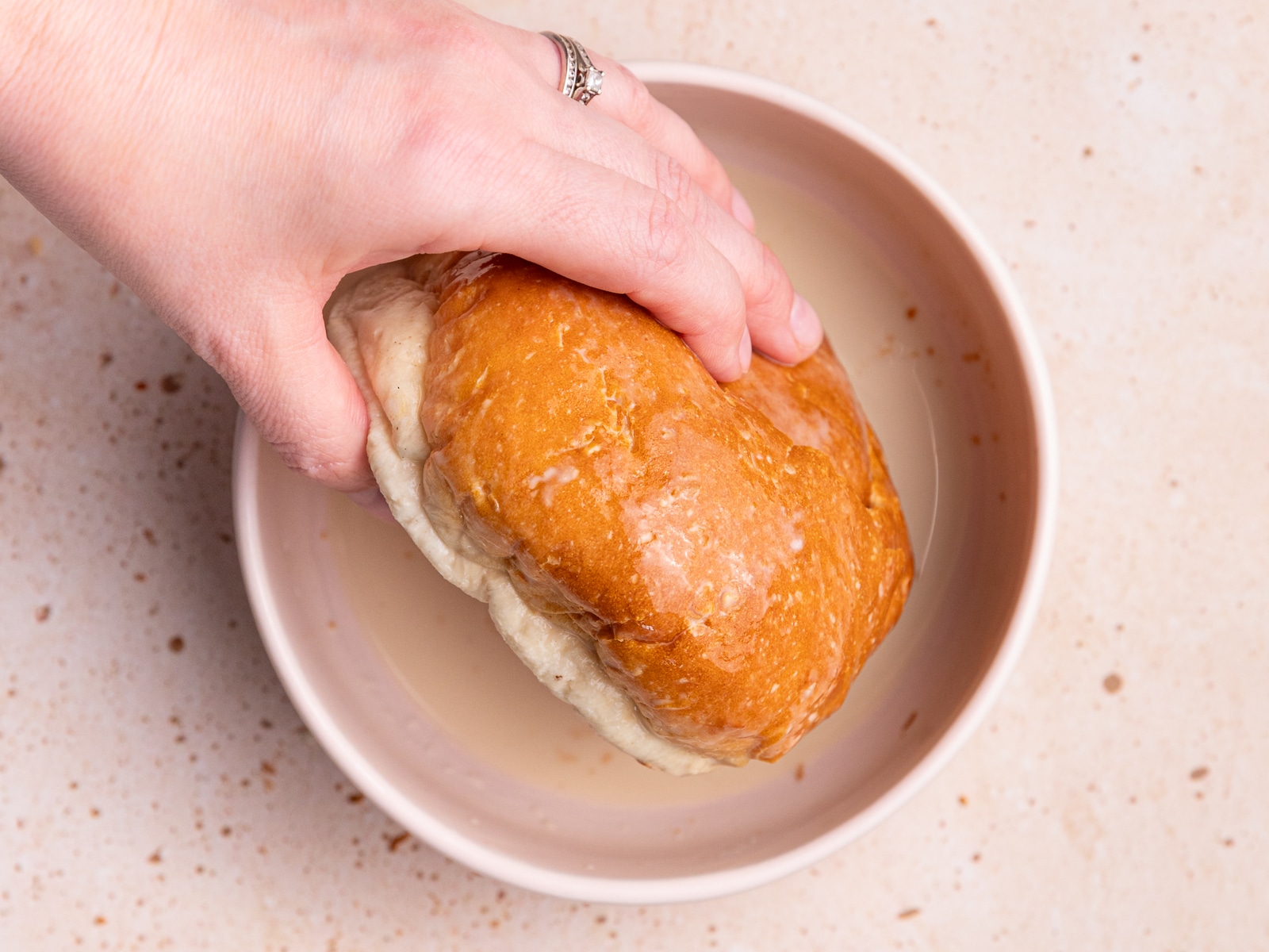 dipping a bread roll in custard