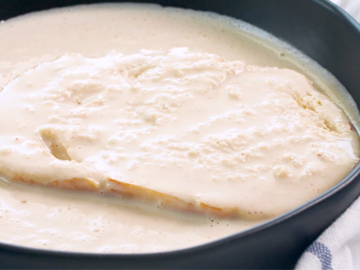 a slice of bread soaking in custard