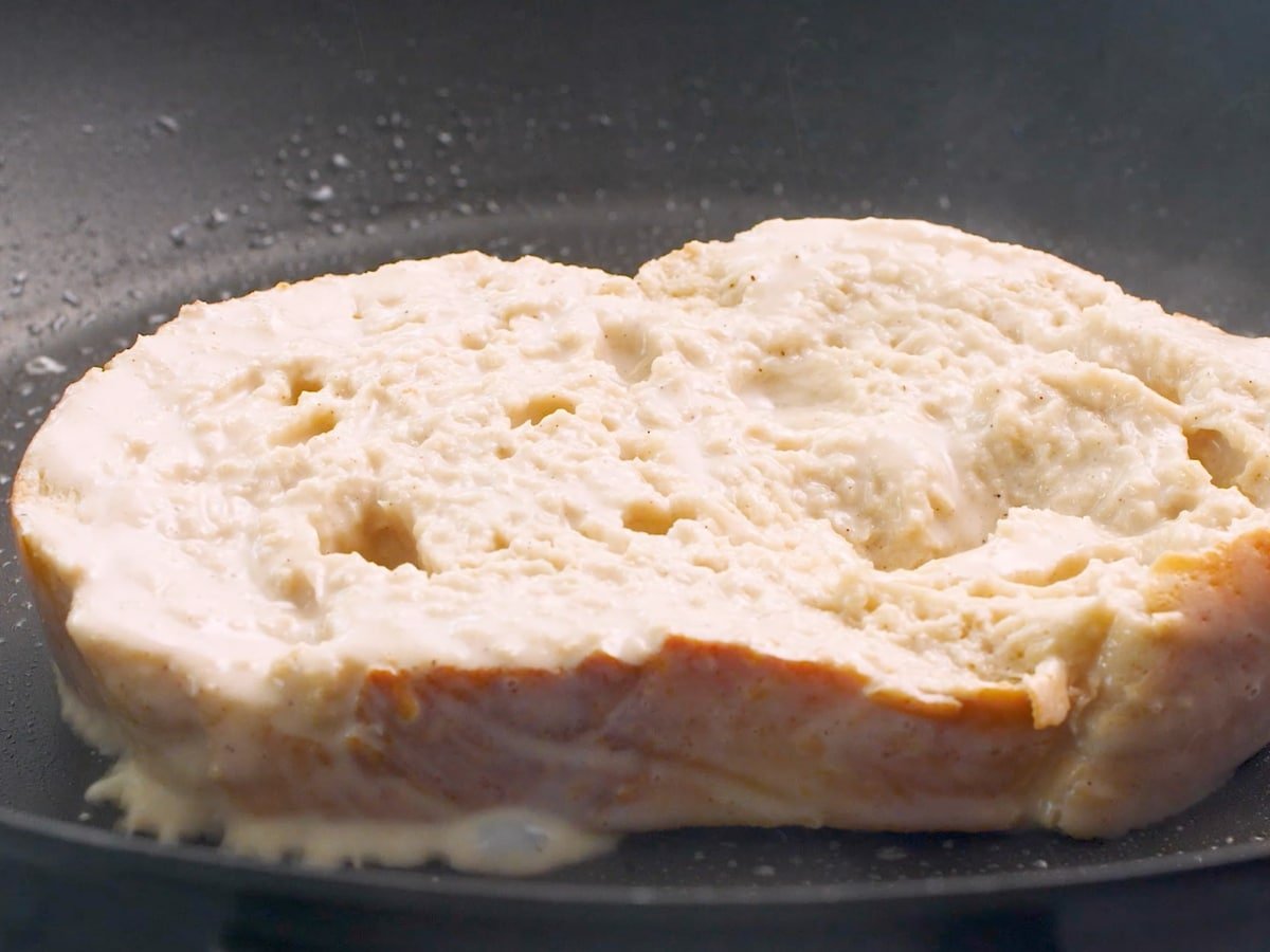 a piece of French toast cooking in a pan