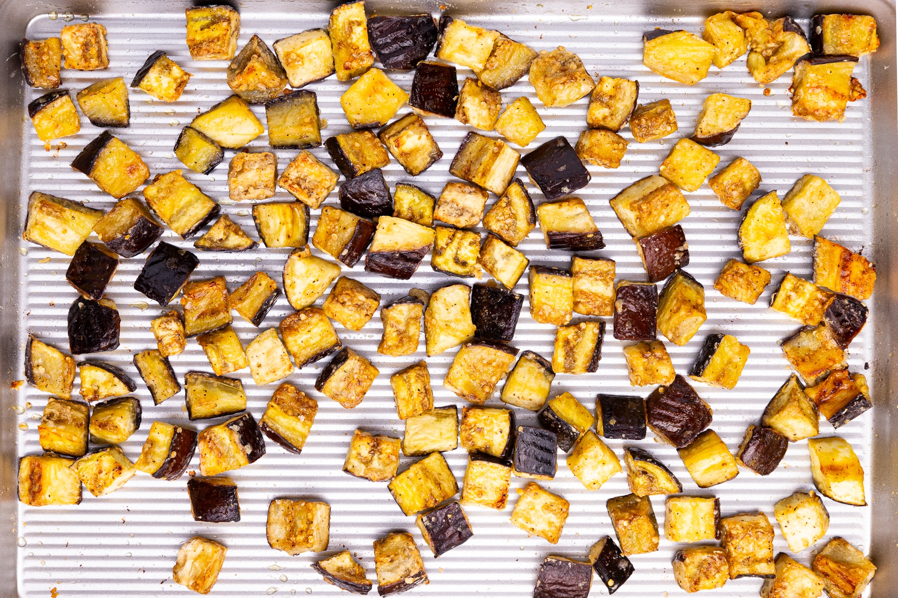 golden cubes of eggplant on a baking tray