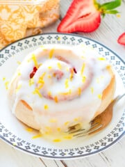 a sticky strawberry lemon sweet roll on a plate