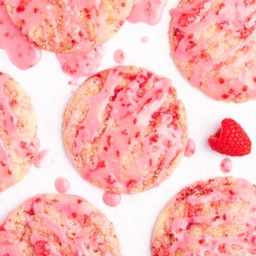 glazed vegan raspberry cookies on a white backdrop, taken from above.
