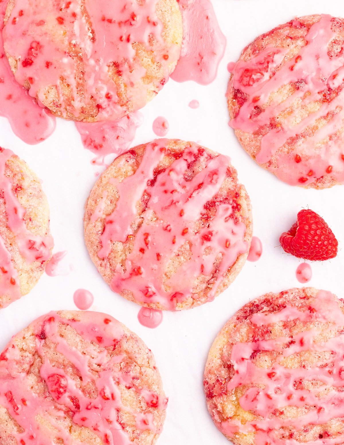 glazed vegan raspberry cookies from a above on a white backdrop
