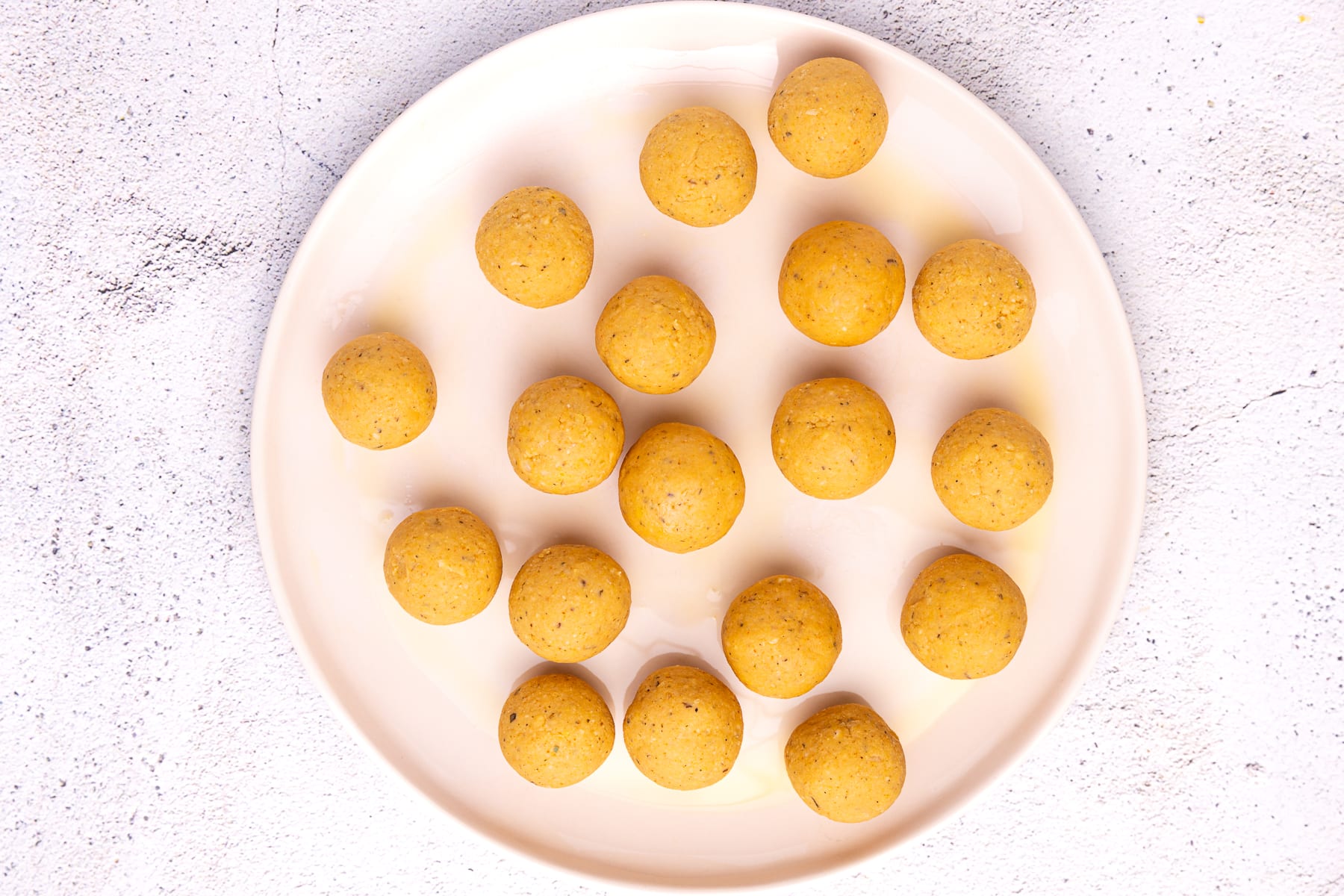 uncooked chickpea meatballs on a plate