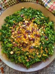 a bowl of massaged kale salad with savory granola