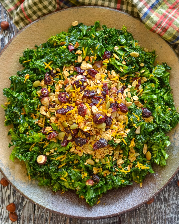 a bowl of massaged kale salad with savory granola
