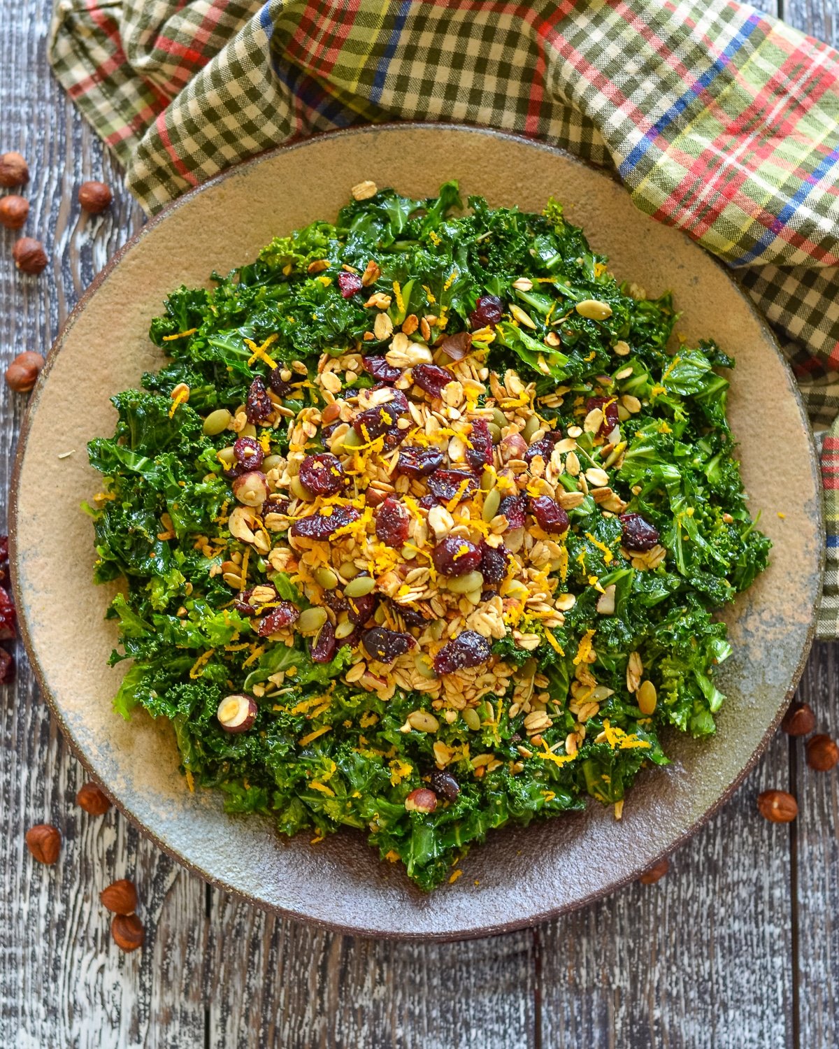 a bowl of massaged kale salad with granola