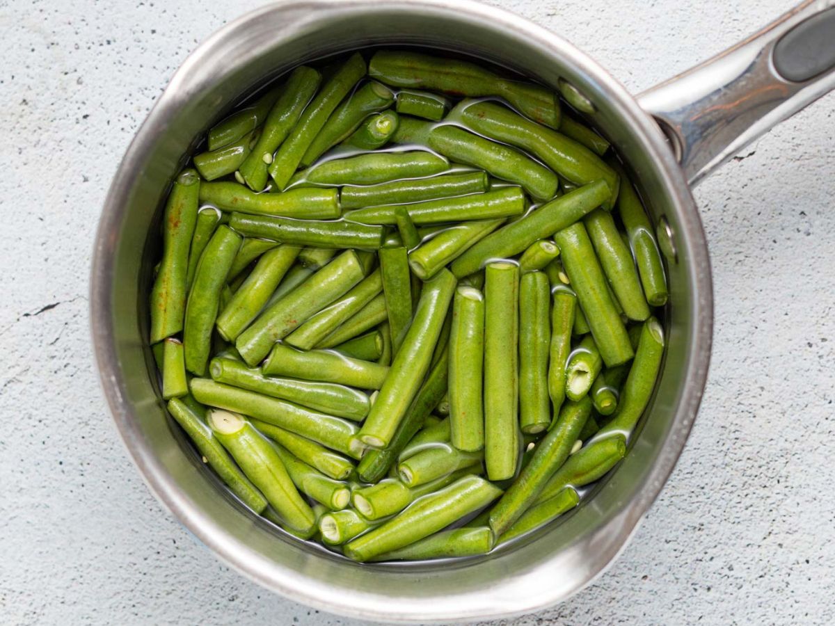 green beans blanching in a pan