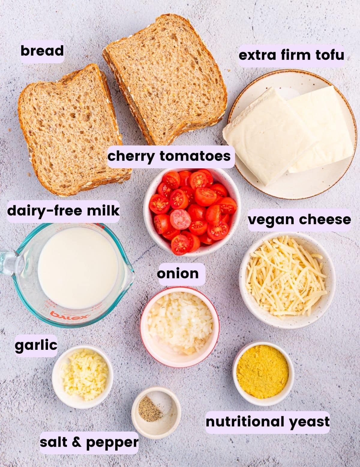 bread, extra firm tofu, cherry tomatoes, dairy-free milk, vegan cheese, onion, garlic, salt, pepper, and nutritional yeast