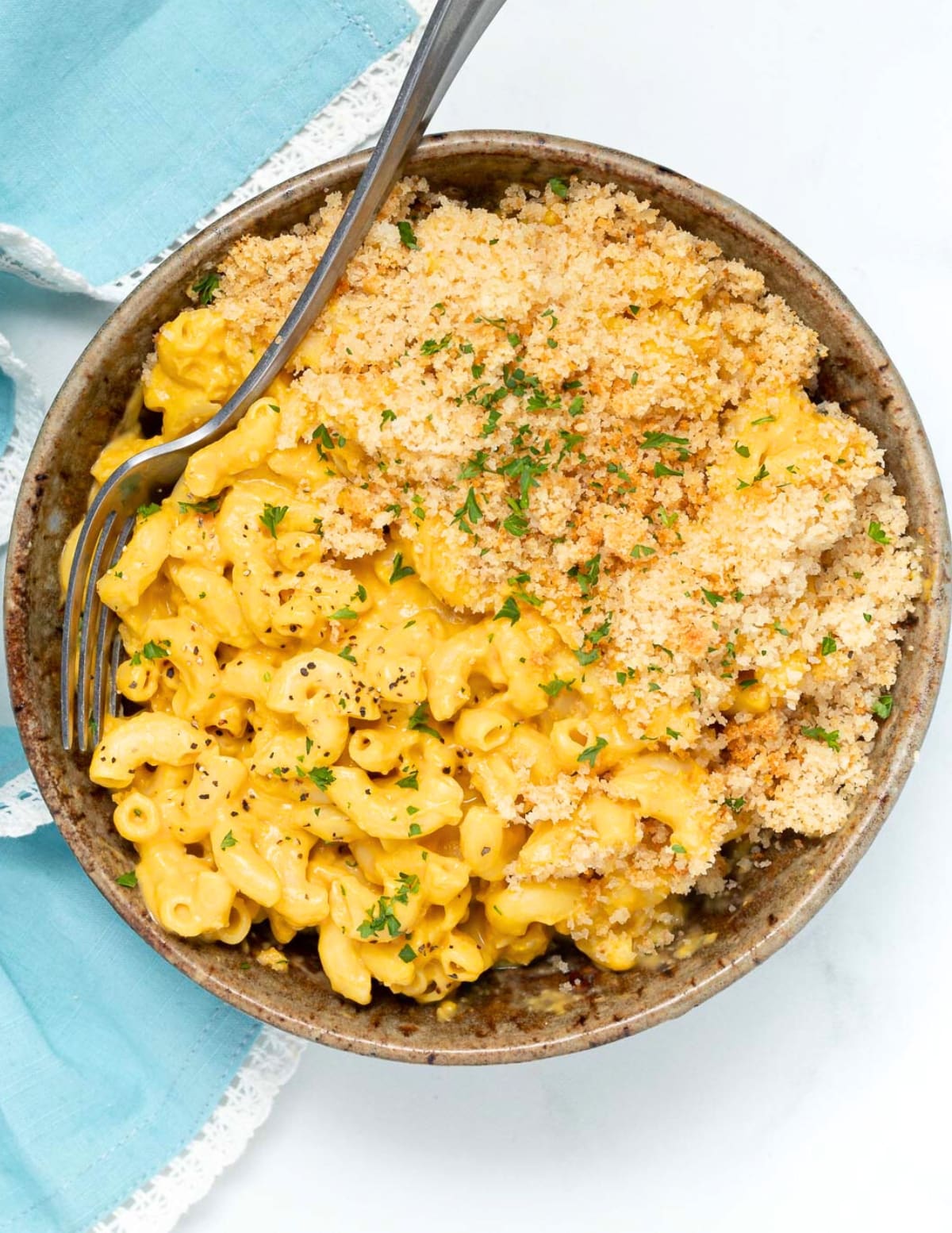 a bowl of vegan mac and cheese garnished with fresh parsley