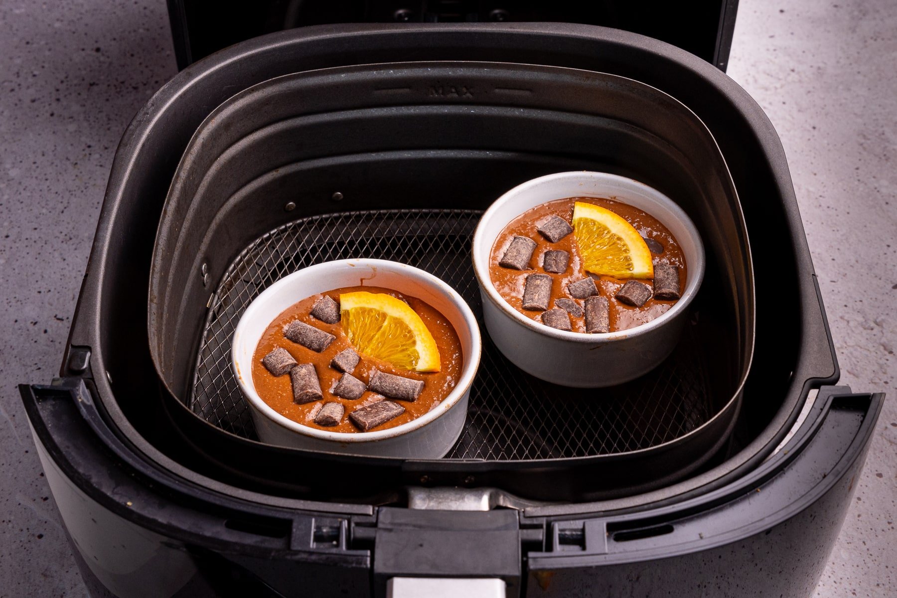 uncooked chocolate orange blended baked oats in an air fryer basket