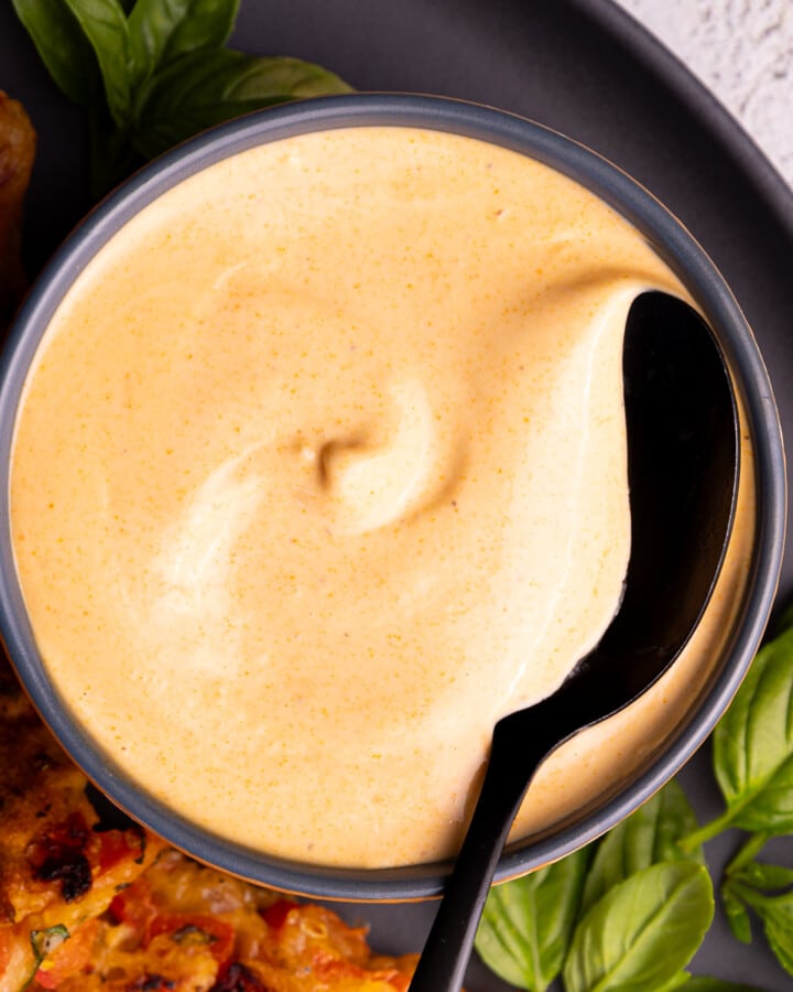 a bowl of creamy vegan sriracha sauce
