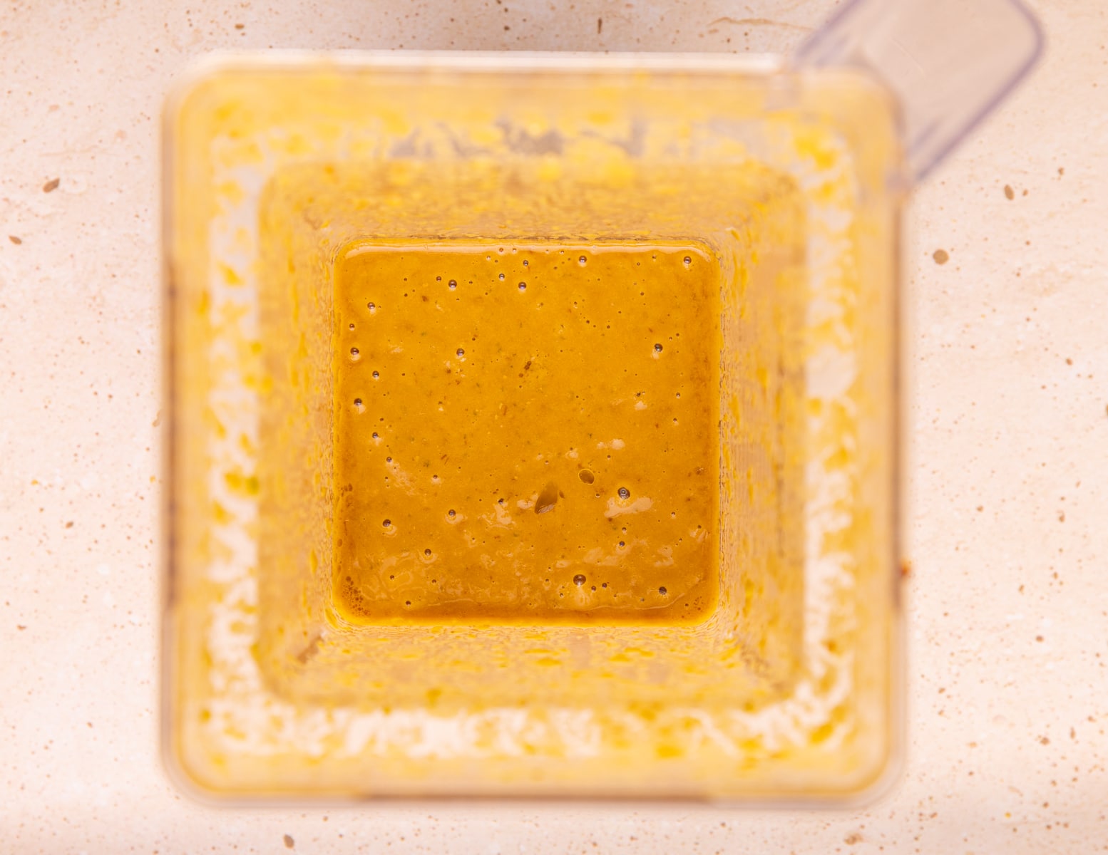 thick, creamy brown dressing in a blender jar