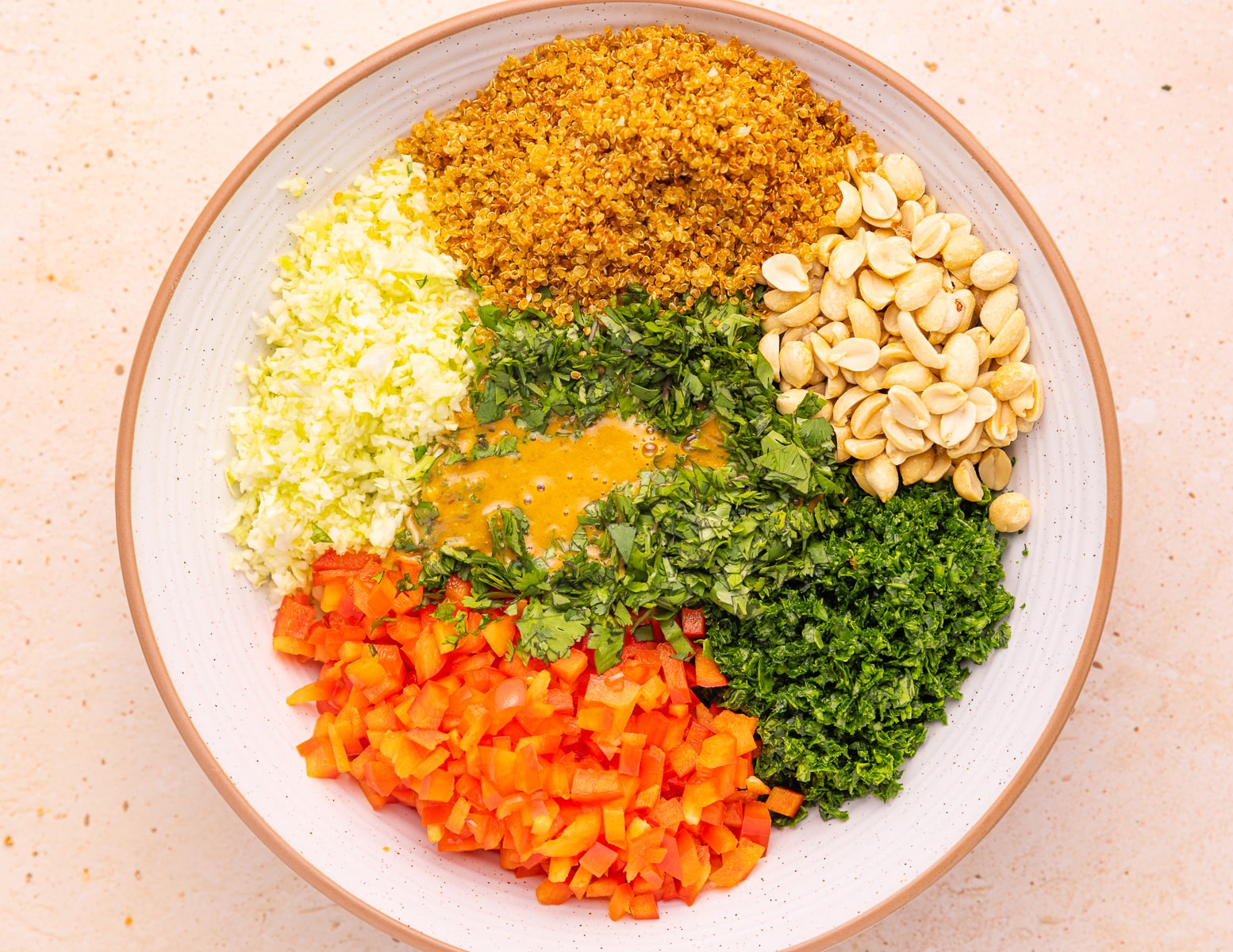 a bowl of untossed crispy quinoa kale salad