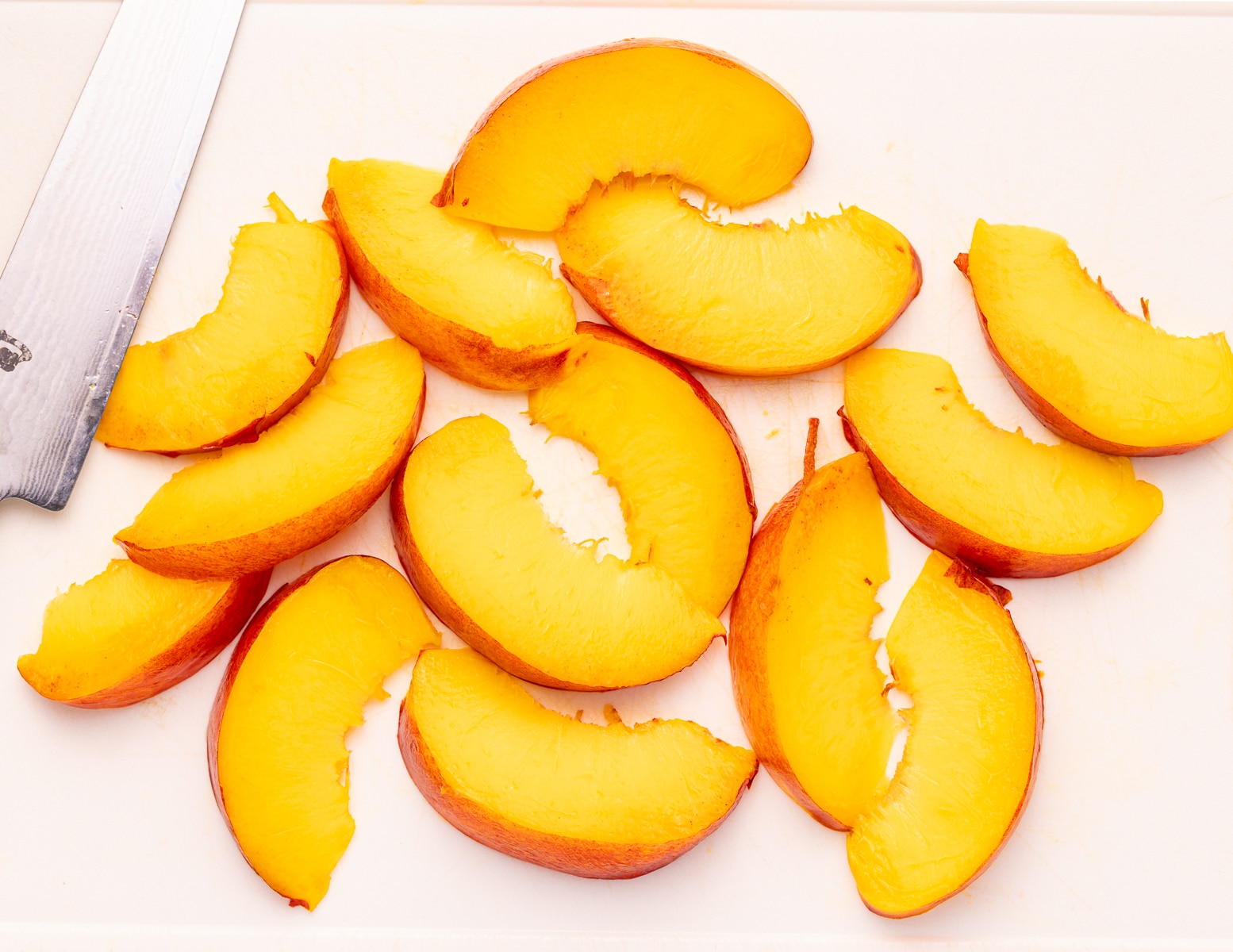 sliced peaches on a cutting board