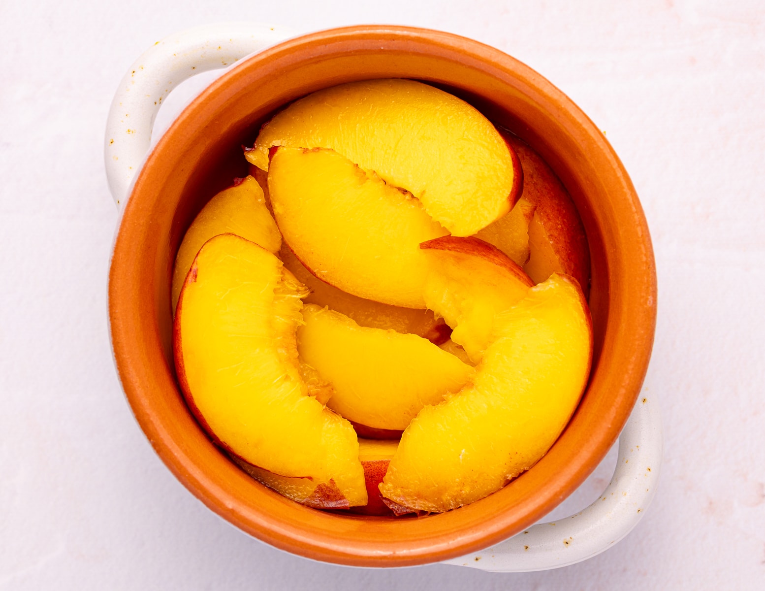 sliced peaches in a small oven-proof dish