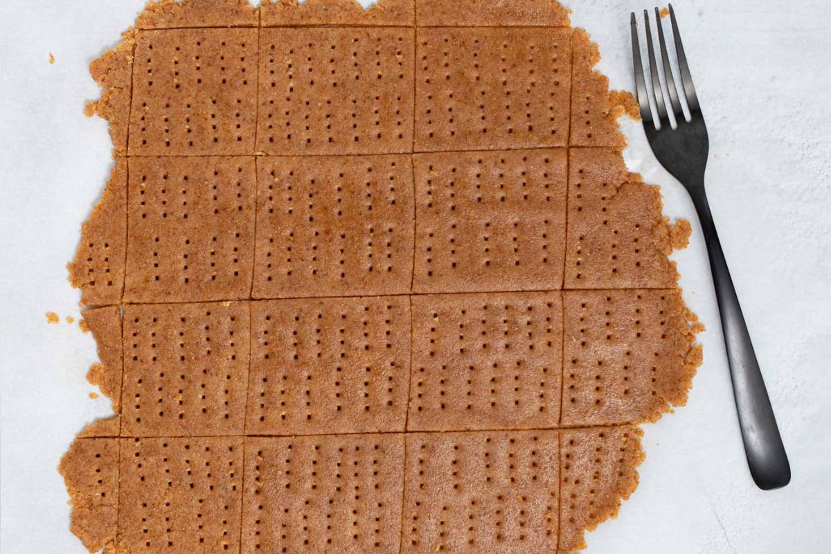 rolled graham cracker dough cut into rectangles and pierced with a fork