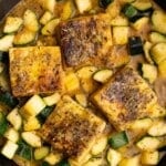 golden tofu cutlets in a pan with zucchini and sauce