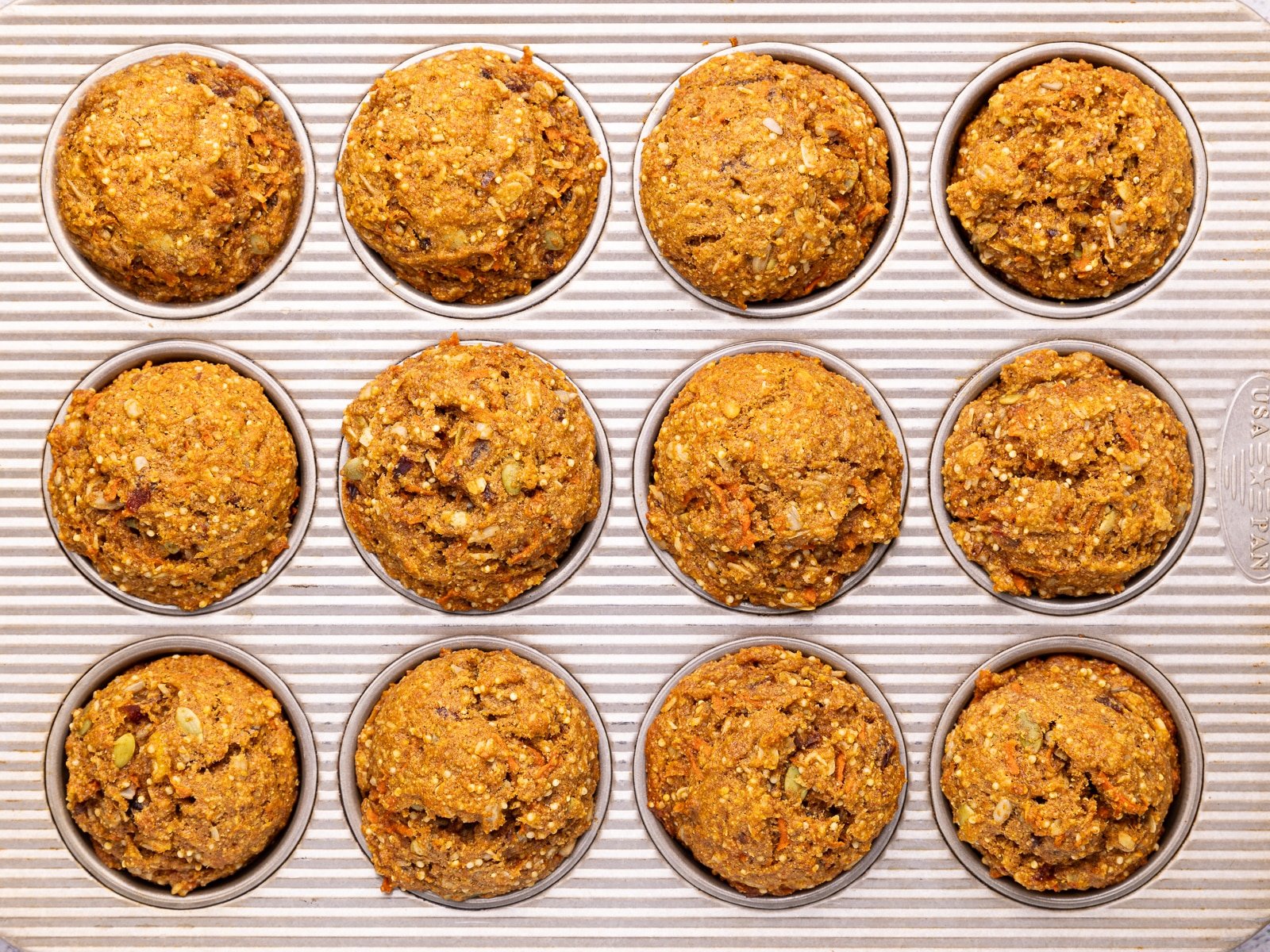 Cooked morning glory muffins in a muffin pan. 