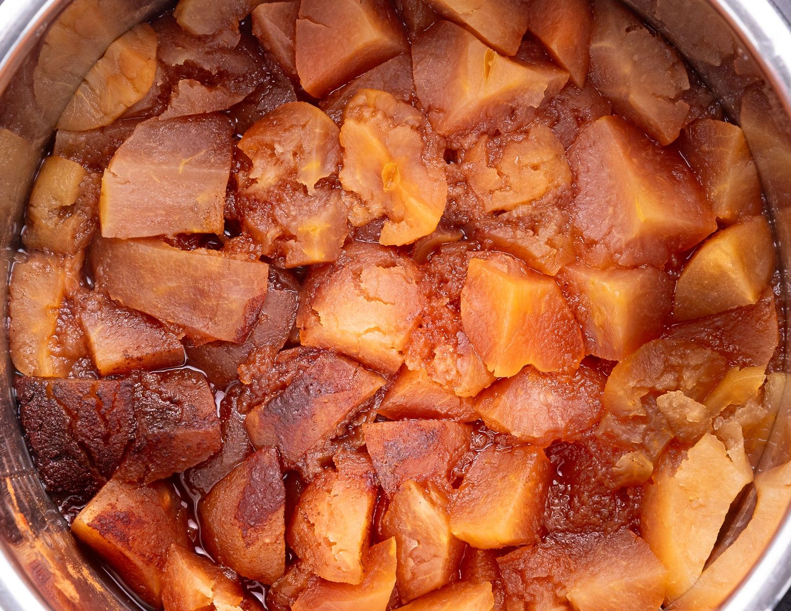 cooked apples, sugar and spices in a slow cooker insert. 