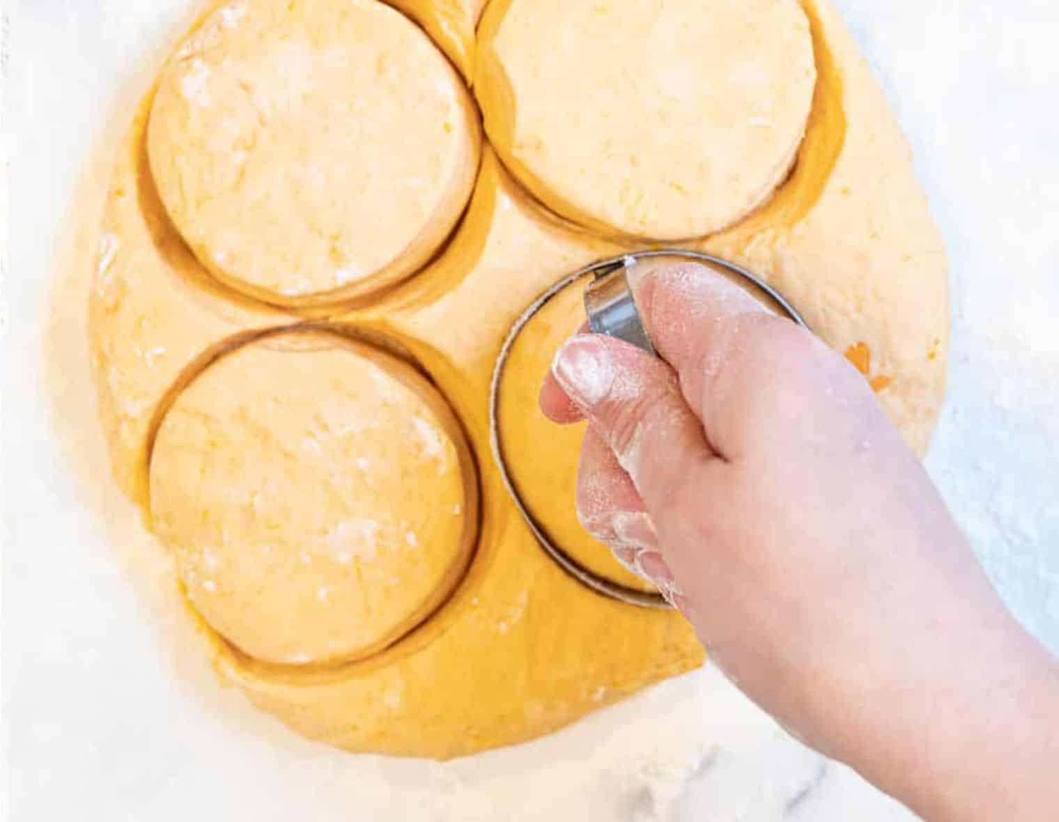 cutting sweet potato biscuits with a round cutter