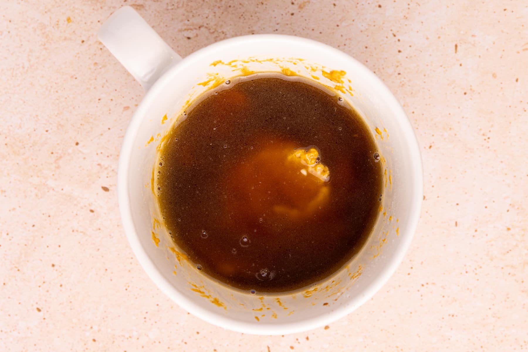 An uncooked pumpkin mug cake.