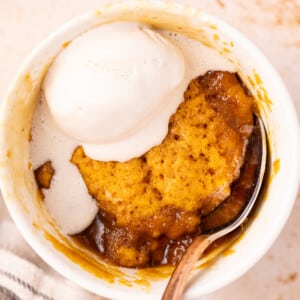 Asaucy caramel-y pumpkin mug cake with a dollop of ice cream.