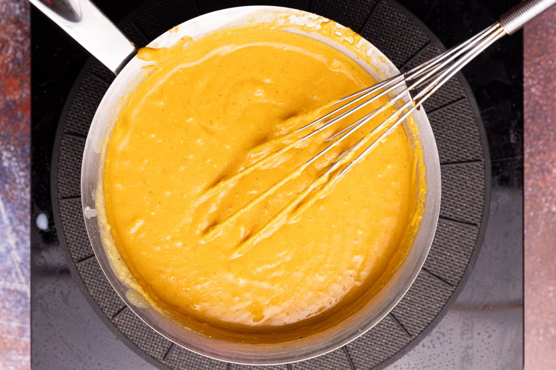 vegan pumpkin cheese sauce in a saucepan