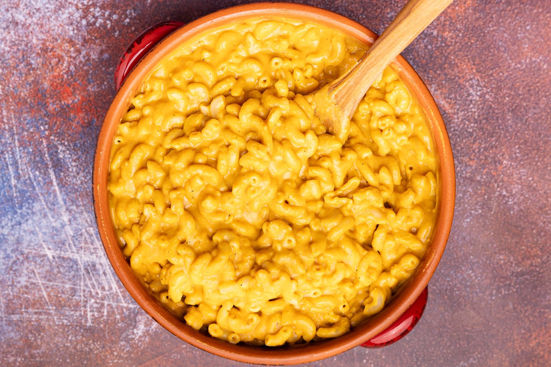 macaroni tossed with lots of cheese sauce in a terracotta dish