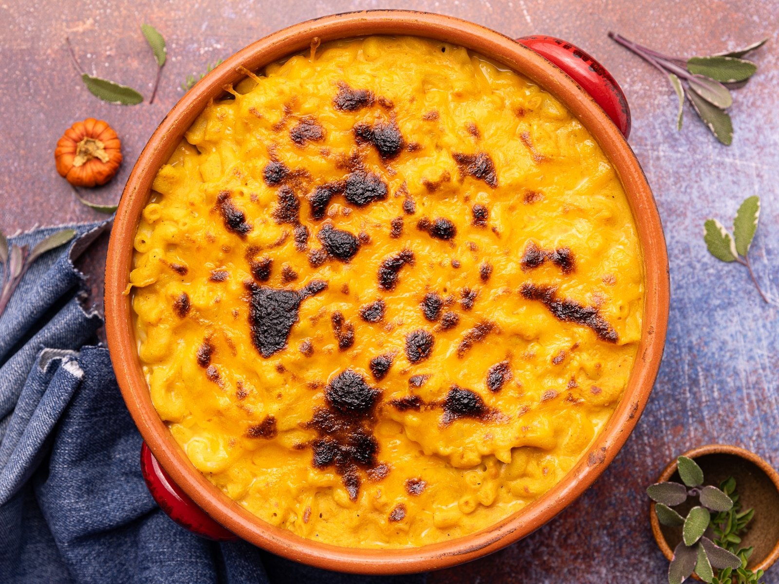 vegan pumpkin mac and cheese topped with lots of melty, caramelized cheese after broiling