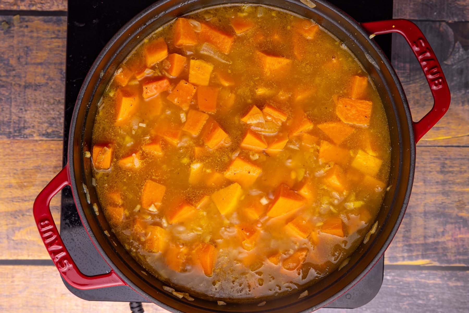 chunky sweet potato soup in a pan prior to blending