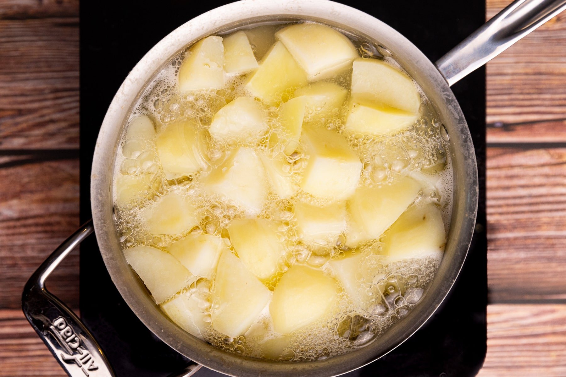 potatoes boiling in a saucepan. 