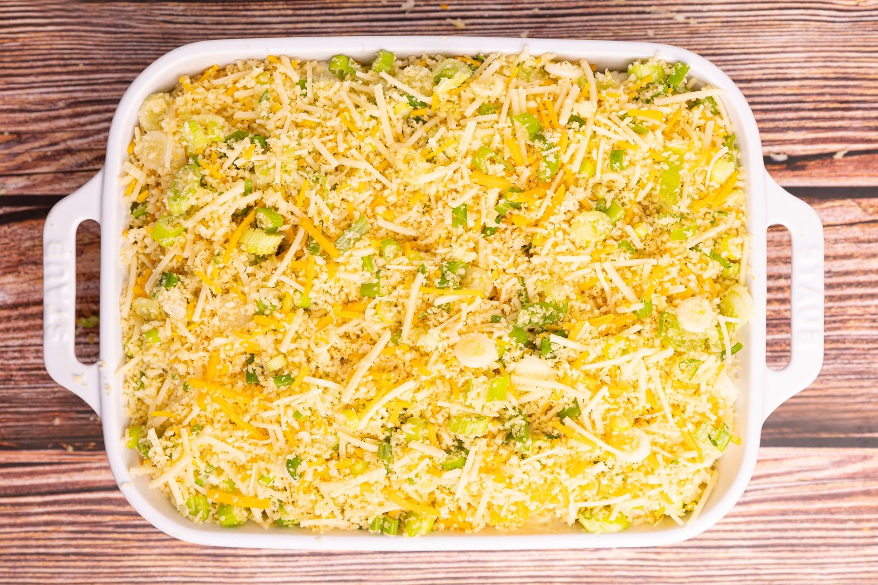 unbaked mashed potato with topping casserole in a baking dish