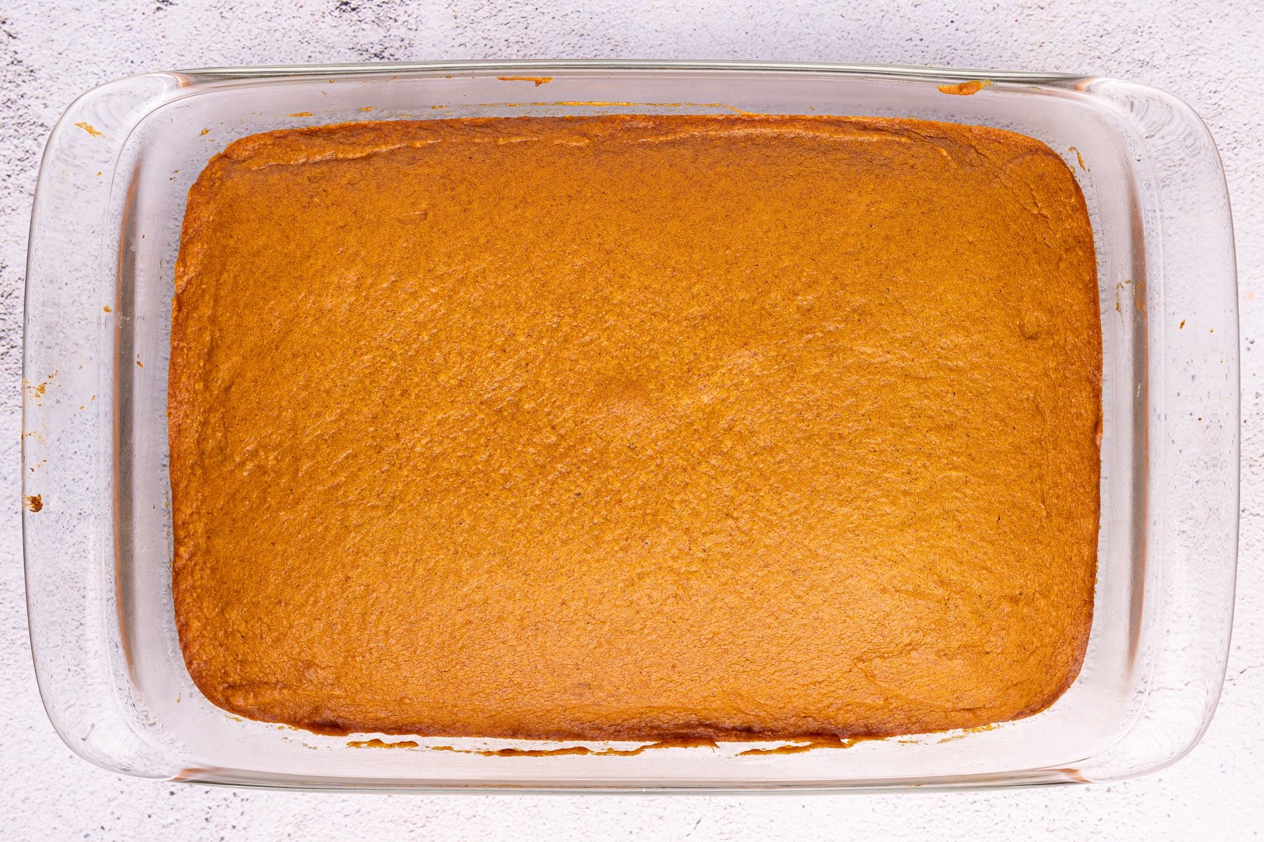 cooked pumpkin cake in a glass baking dish