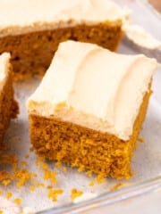 a slice of vegan pumpkin cake with brown sugar frosting