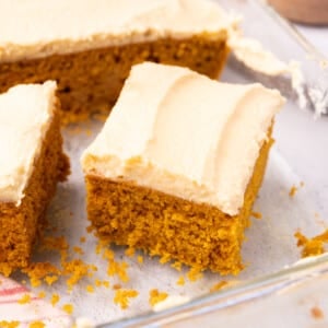 a slice of vegan pumpkin cake with brown sugar frosting