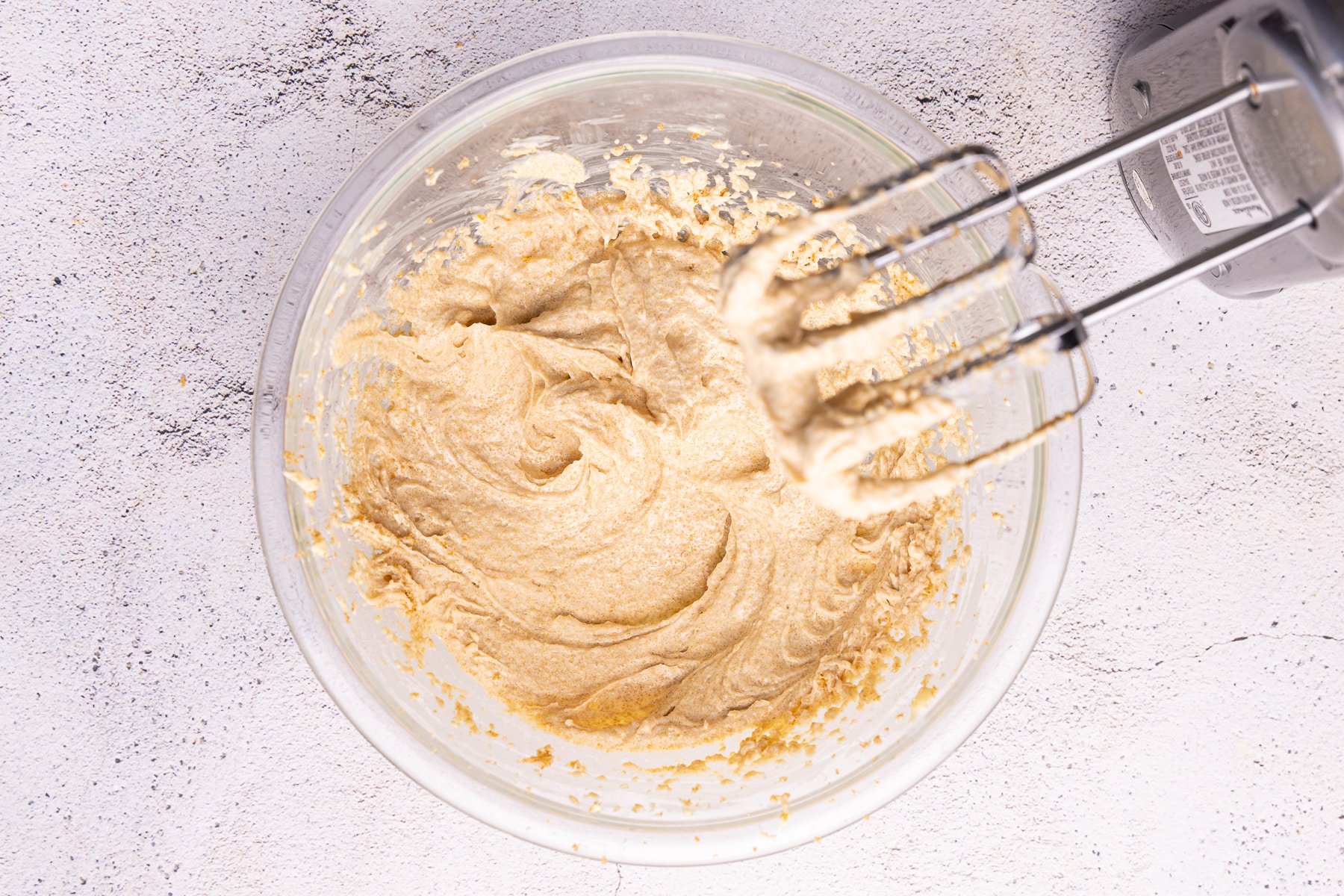 frosting being whipped in a bowl