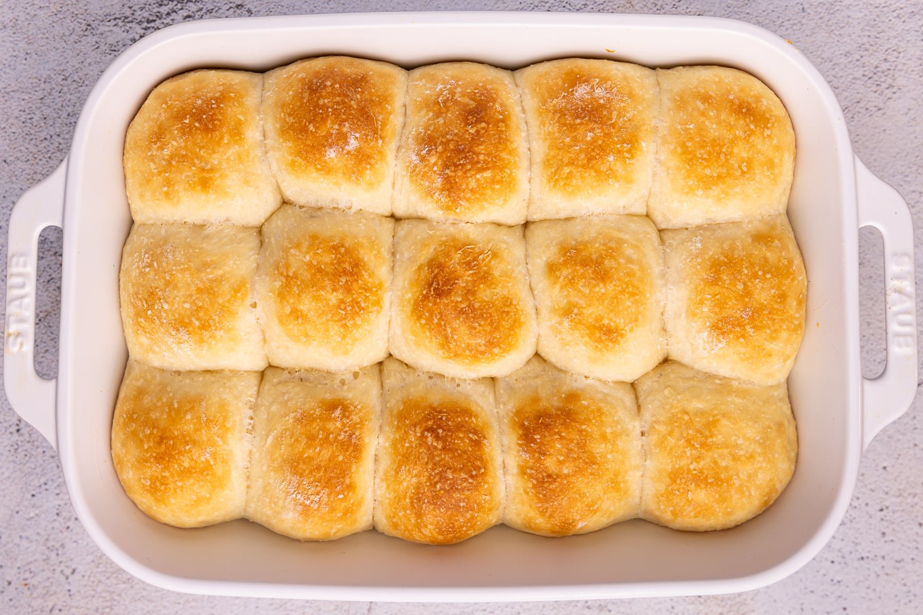 cooked dinner rolls in a ceramic dish