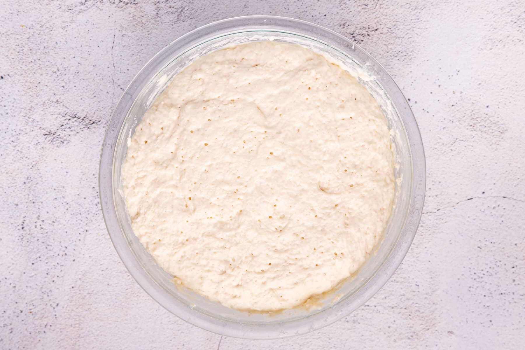 Fluffy well-risen bread dough in a bowl